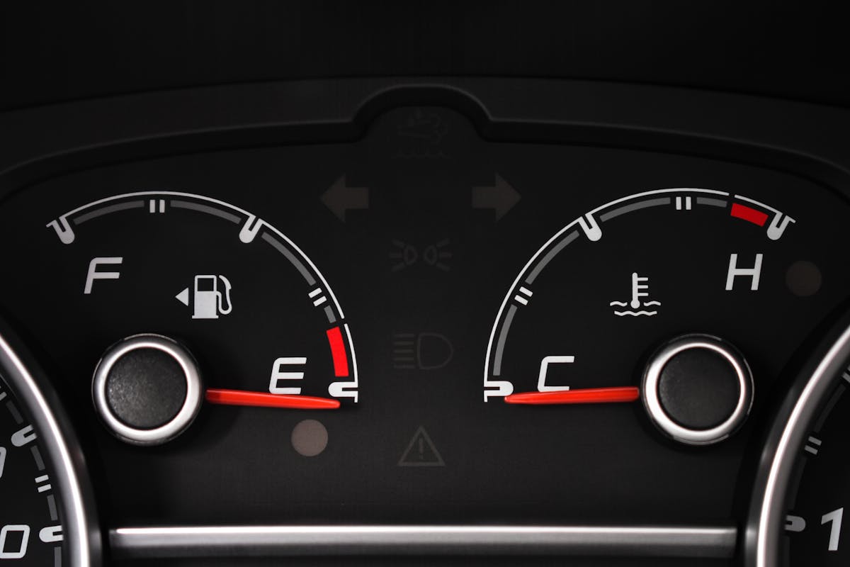 A close-up of dashboard gauges showing pressure and temperature.